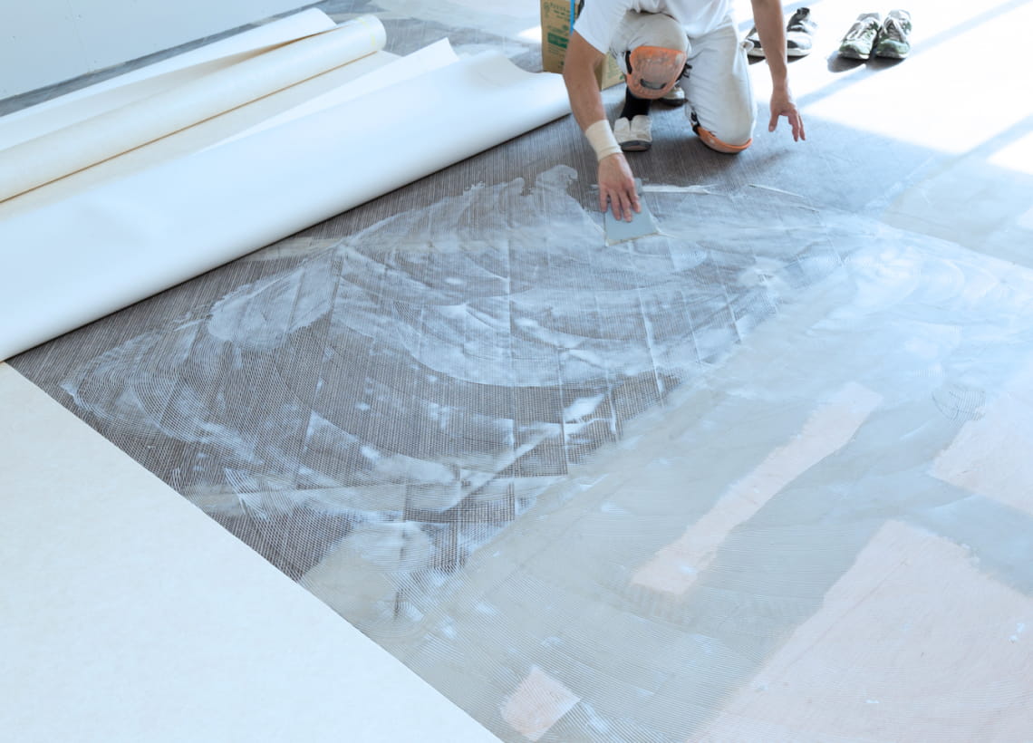 クッションフロア工事をする作業員の写真